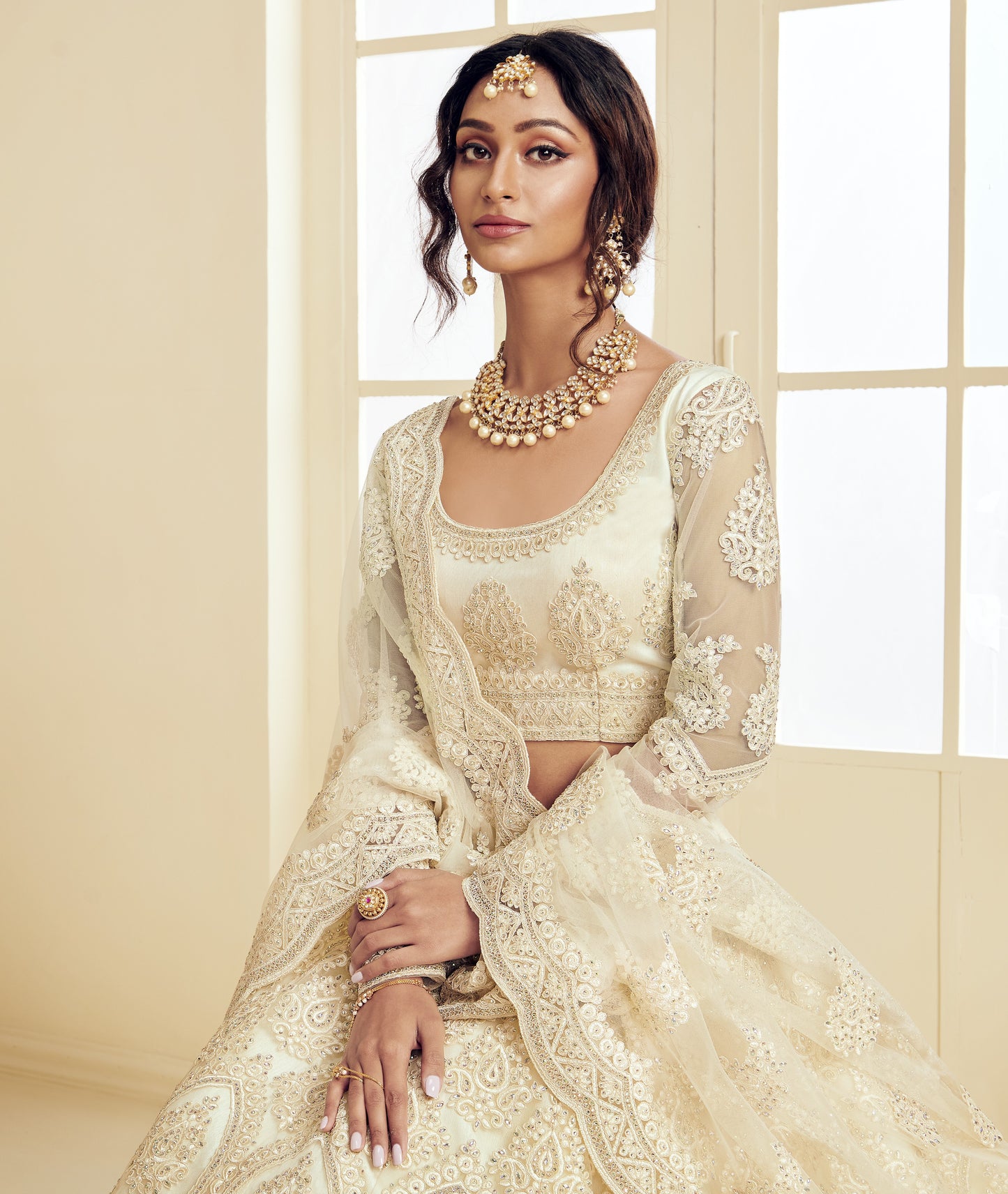 Off White Heavy Embroidered Net Lehenga