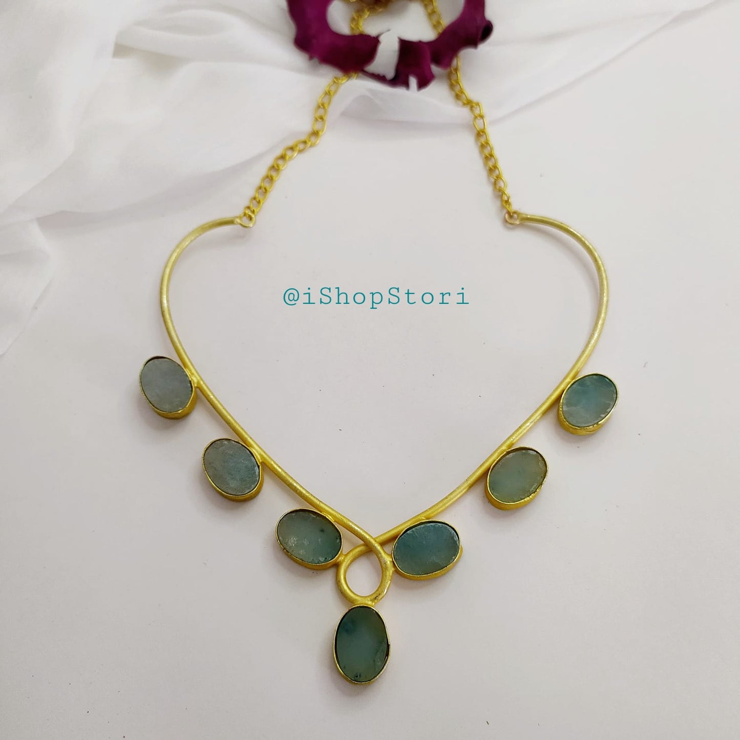 Antique gold necklace with raw stones in a bold statement design full view.