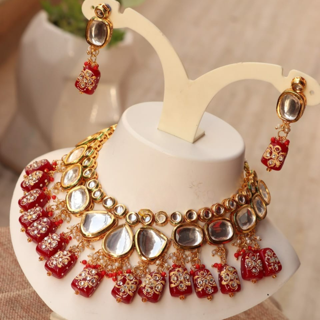 Red Tanjore kundan necklace in a gold finish.