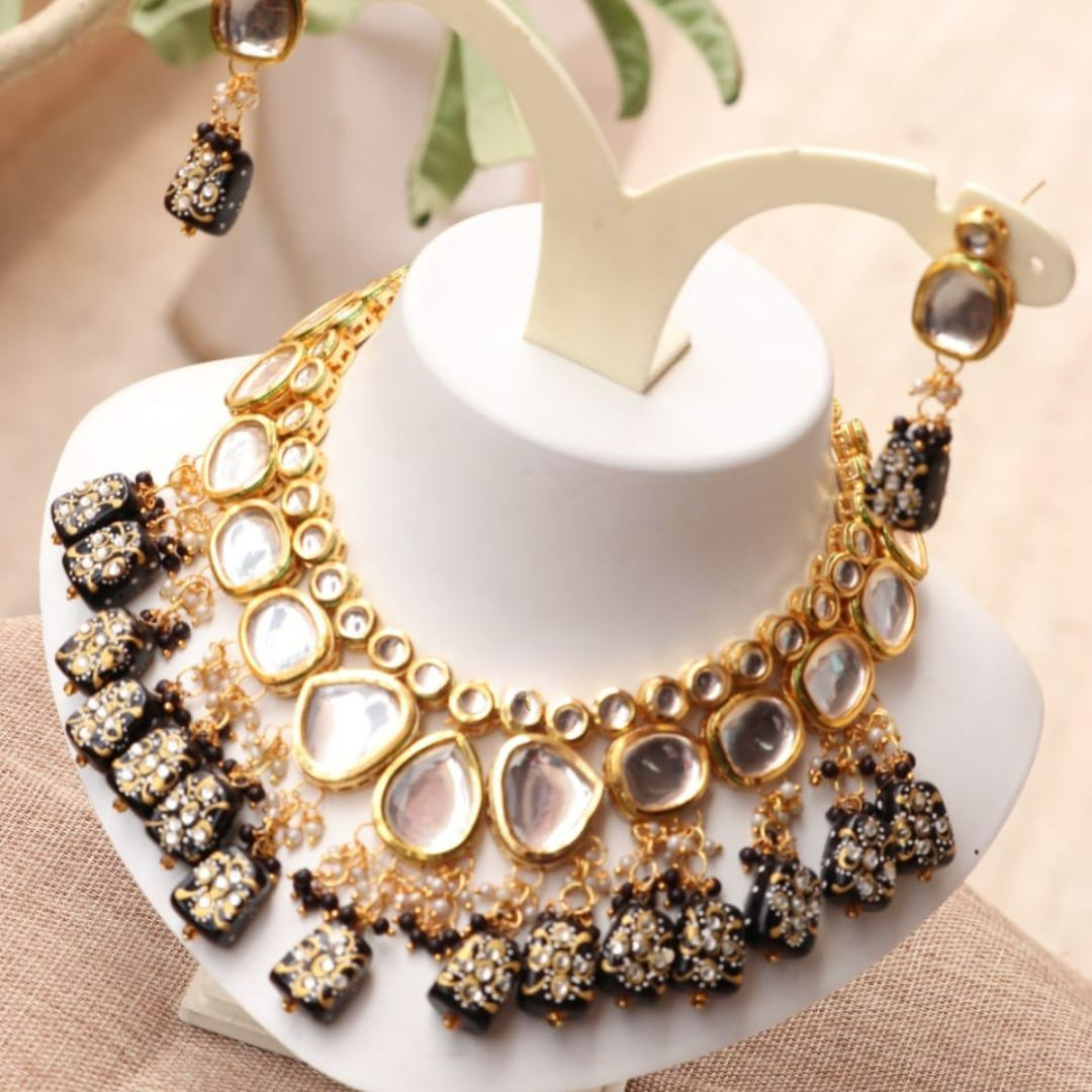 Black gold choker necklace with traditional kundan stones.