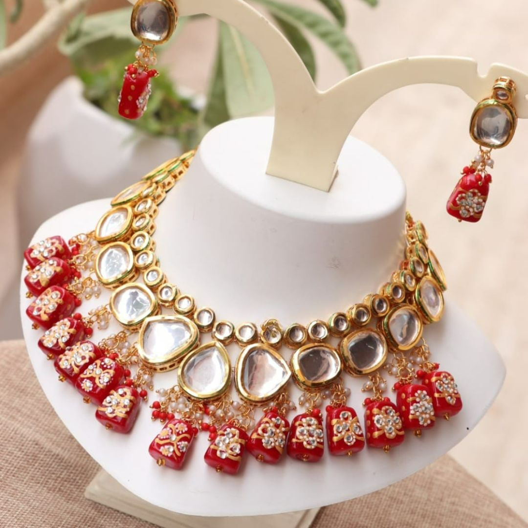 Bright red gold choker necklace with intricate kundan details.