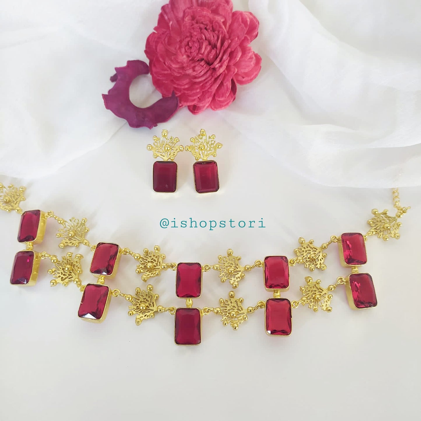 Glossy white stone necklace with a double-layer design and dark red earrings.