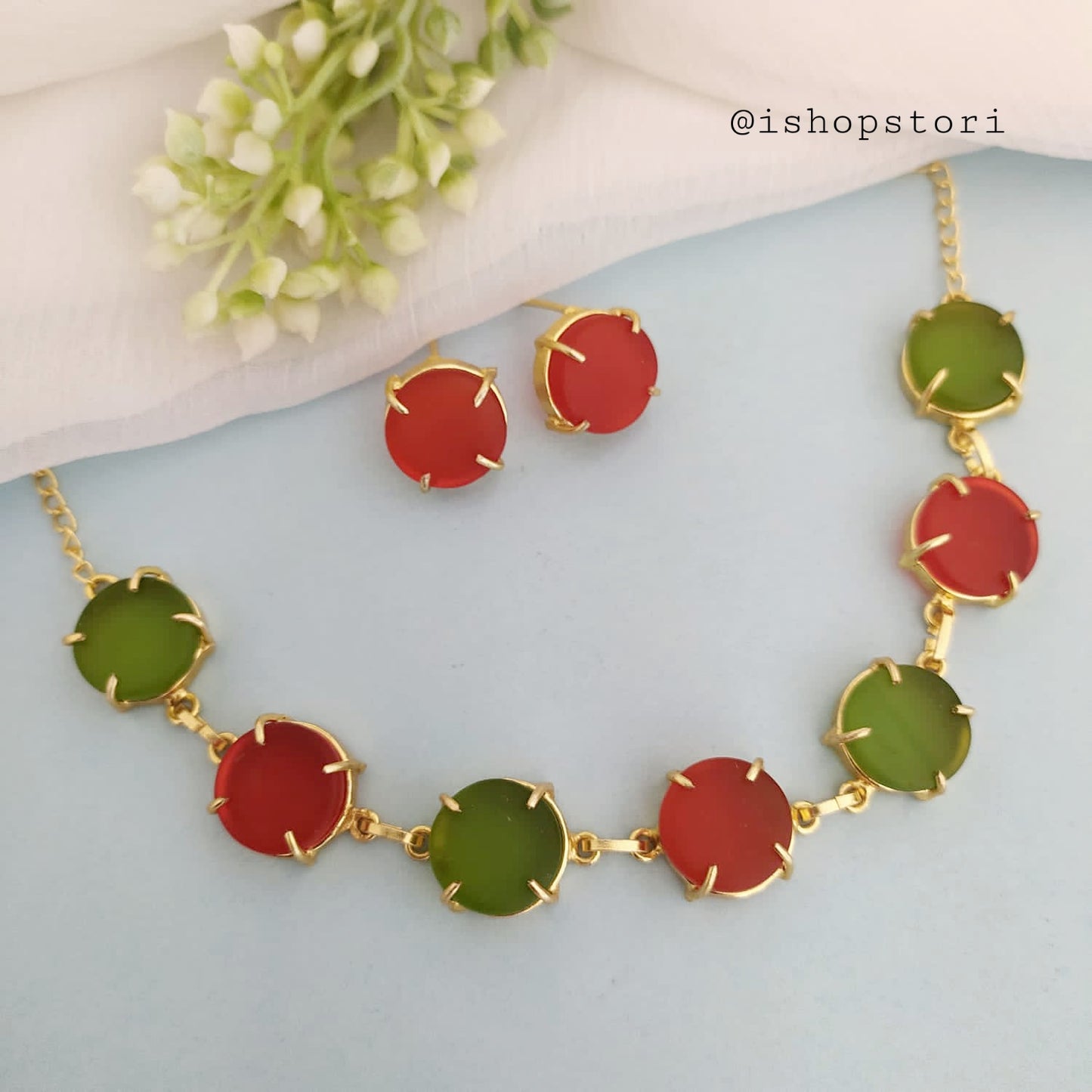 Multi-color raw stone claw necklace in a stylish design with light red earrings.