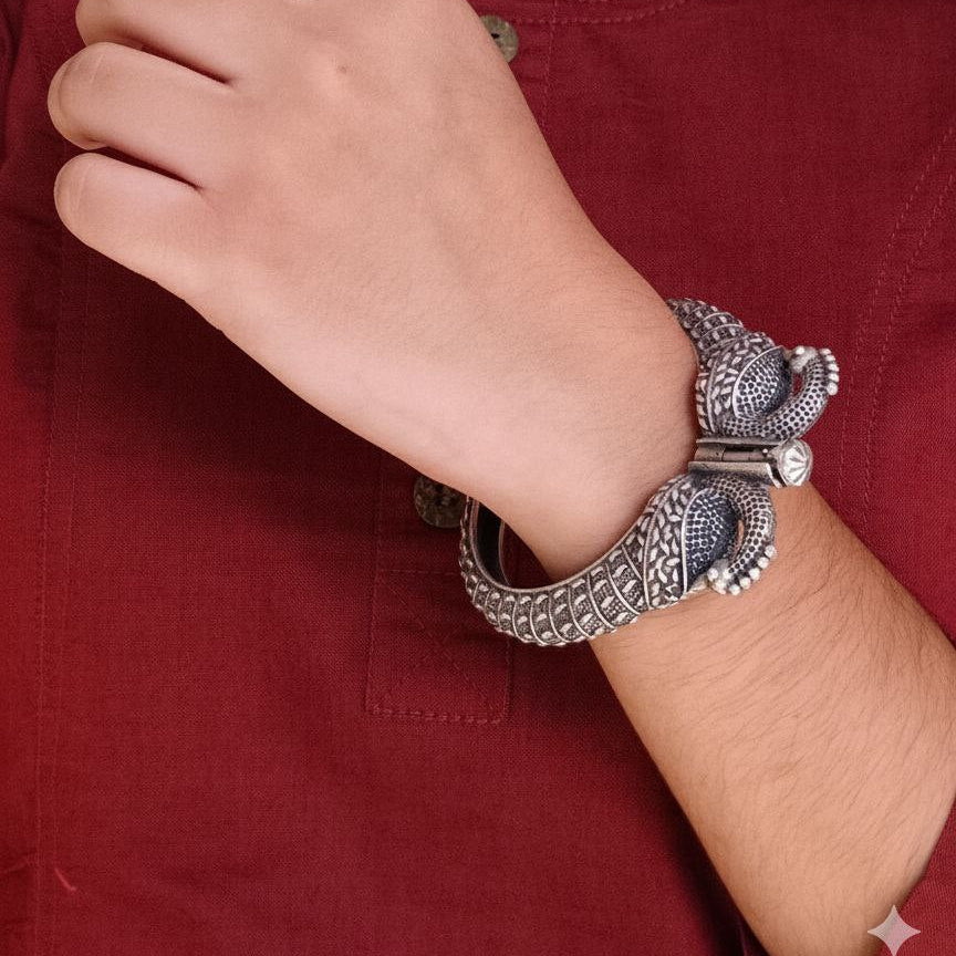 Person wearing a silver bracelet on a red shirt