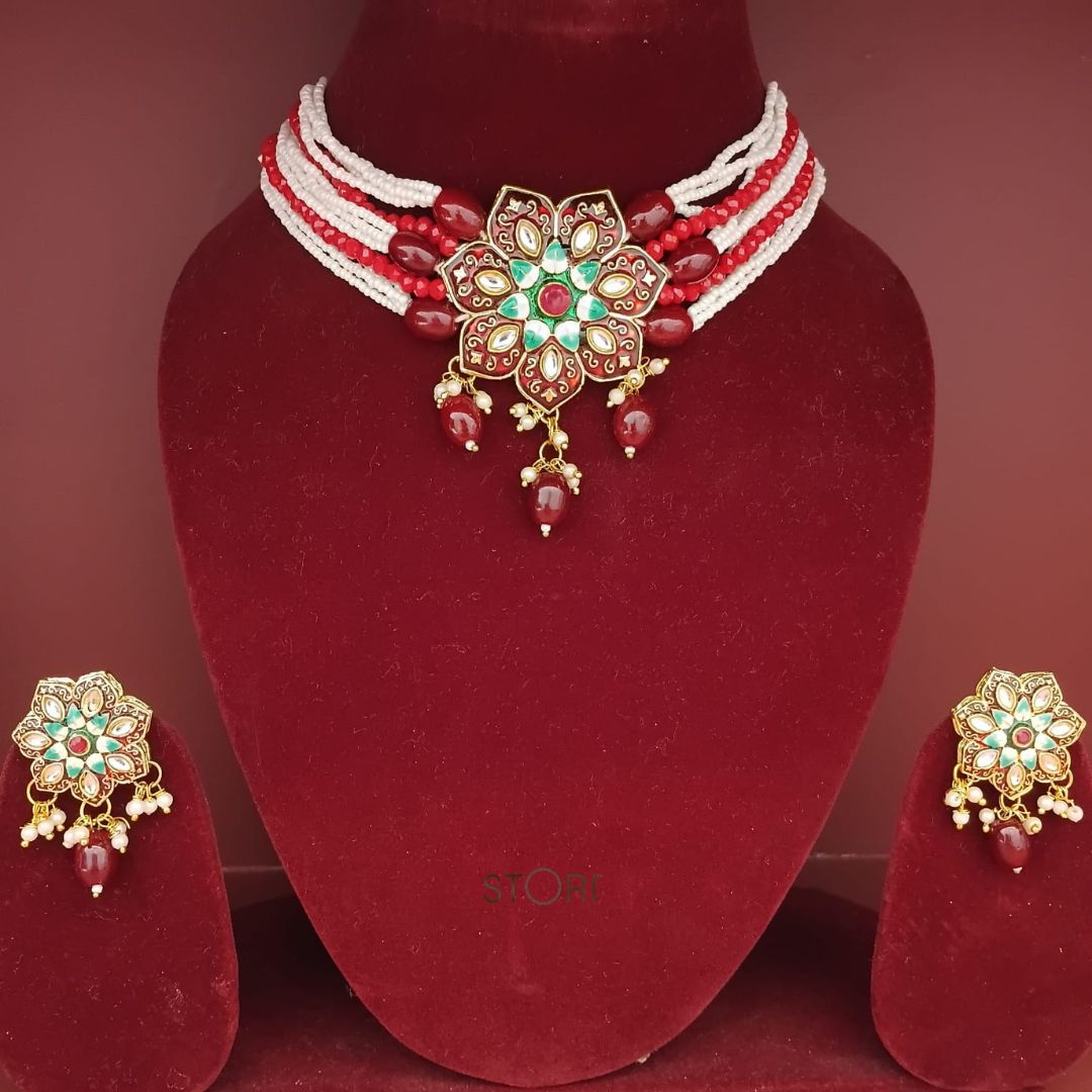 Jewelry set with necklace and earrings on a red stand