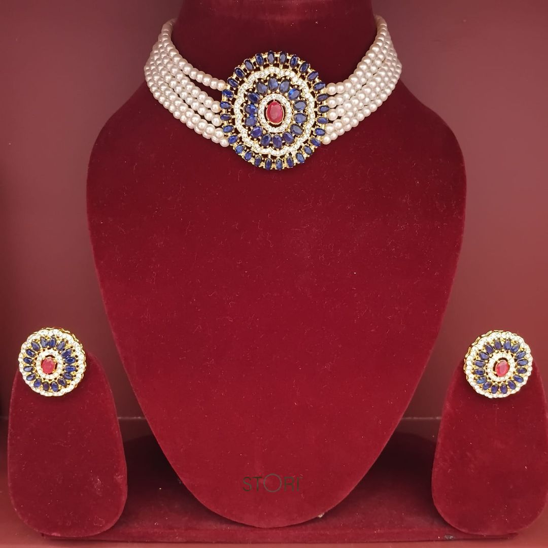 Jewelry set with a necklace and earrings on a red stand