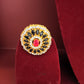 Decorative ring with gemstones on a red velvet stand