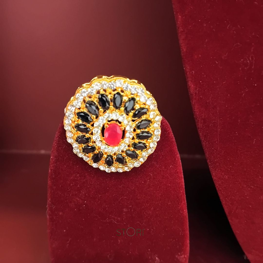 Decorative ring with gemstones on a red velvet stand