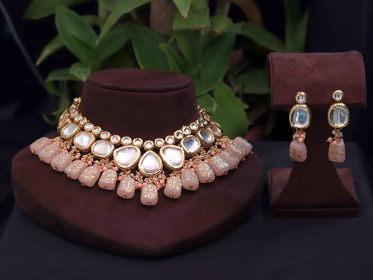 Peach Tanjore kundan necklace set with intricate design.