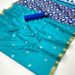 Turquoise saree with floral patterns and a blue blouse on a white background
