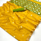 Yellow saree with green border and flower patterns on a white background