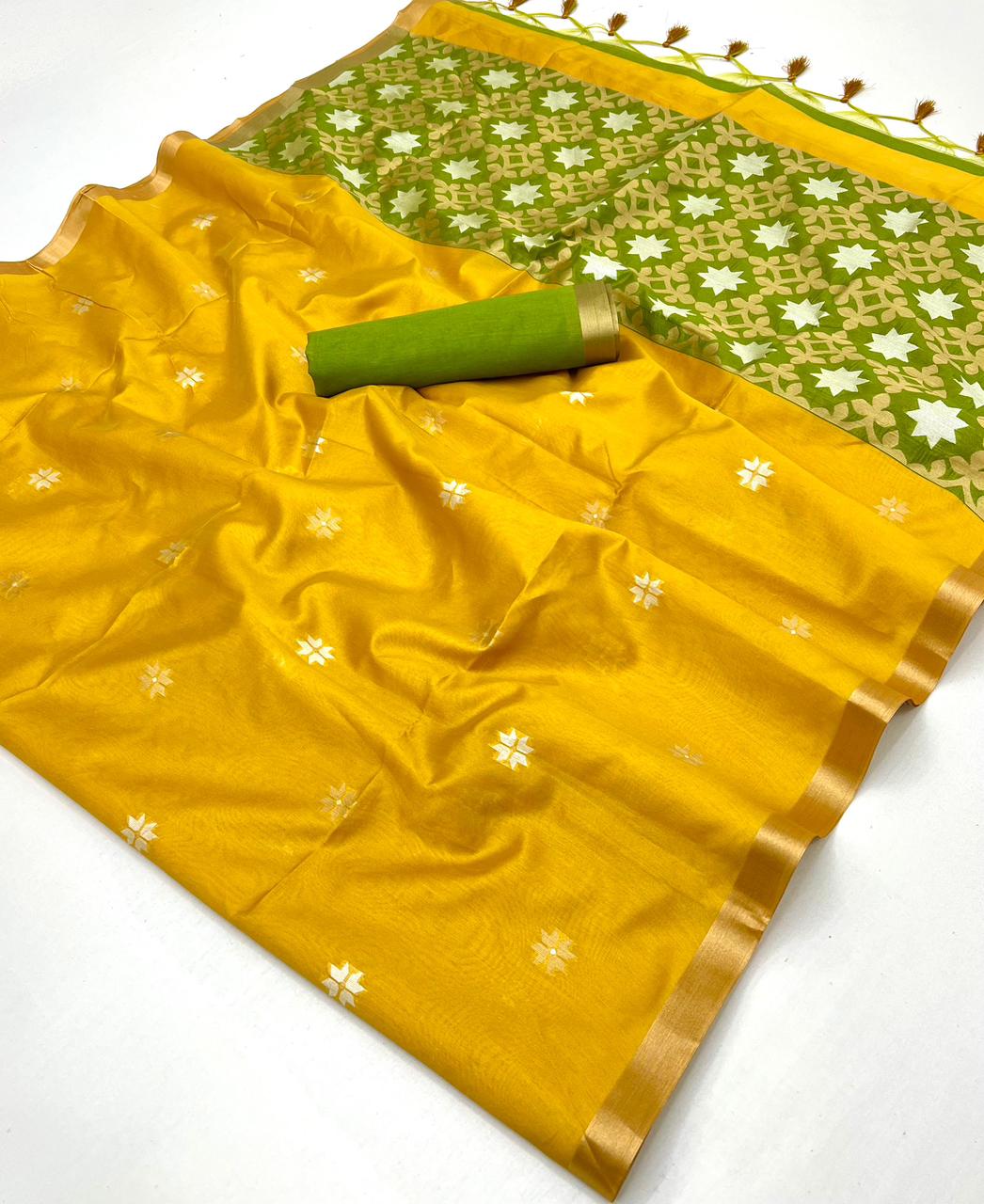 Yellow saree with green border and flower patterns on a white background