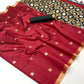 Red saree with gold and white patterns on a white background