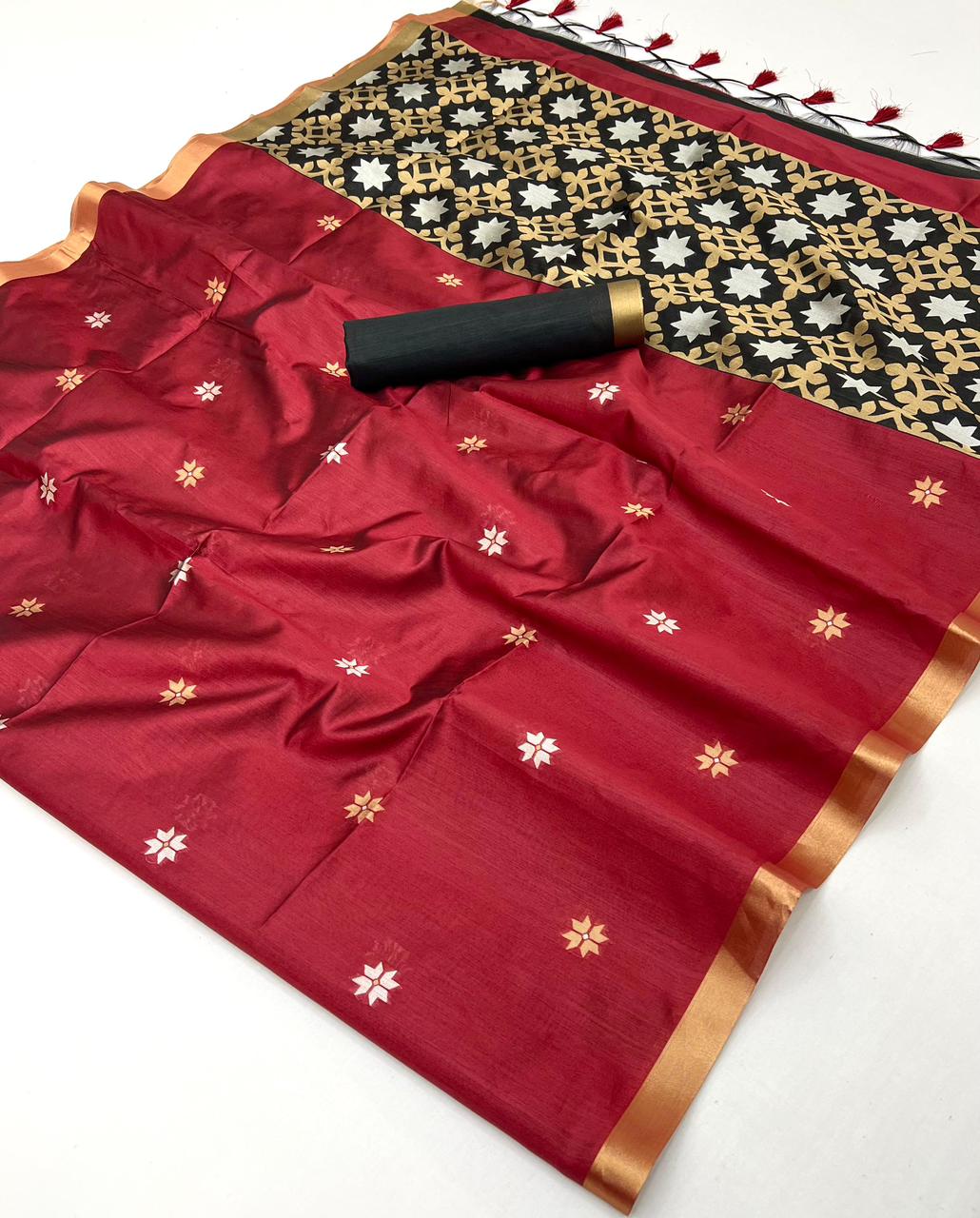 Red saree with gold and white patterns on a white background