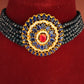Jewelry set with a decorative brooch on a red background