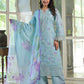 Woman wearing a light blue embroidered outfit with a matching dupatta in a bright room.