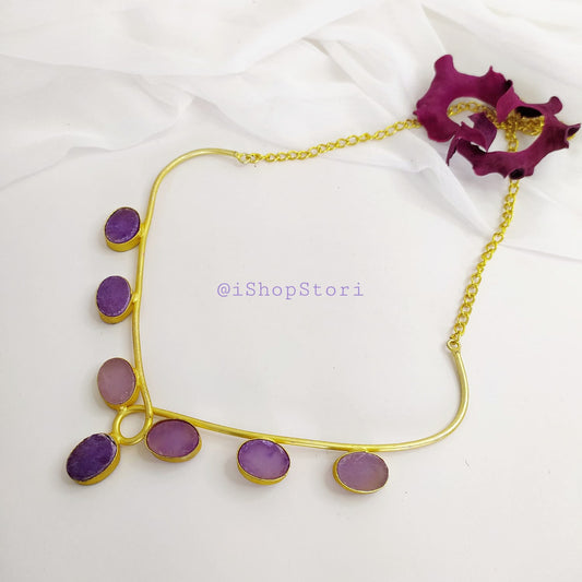 Antique gold necklace with raw stones in a bold statement design front view.