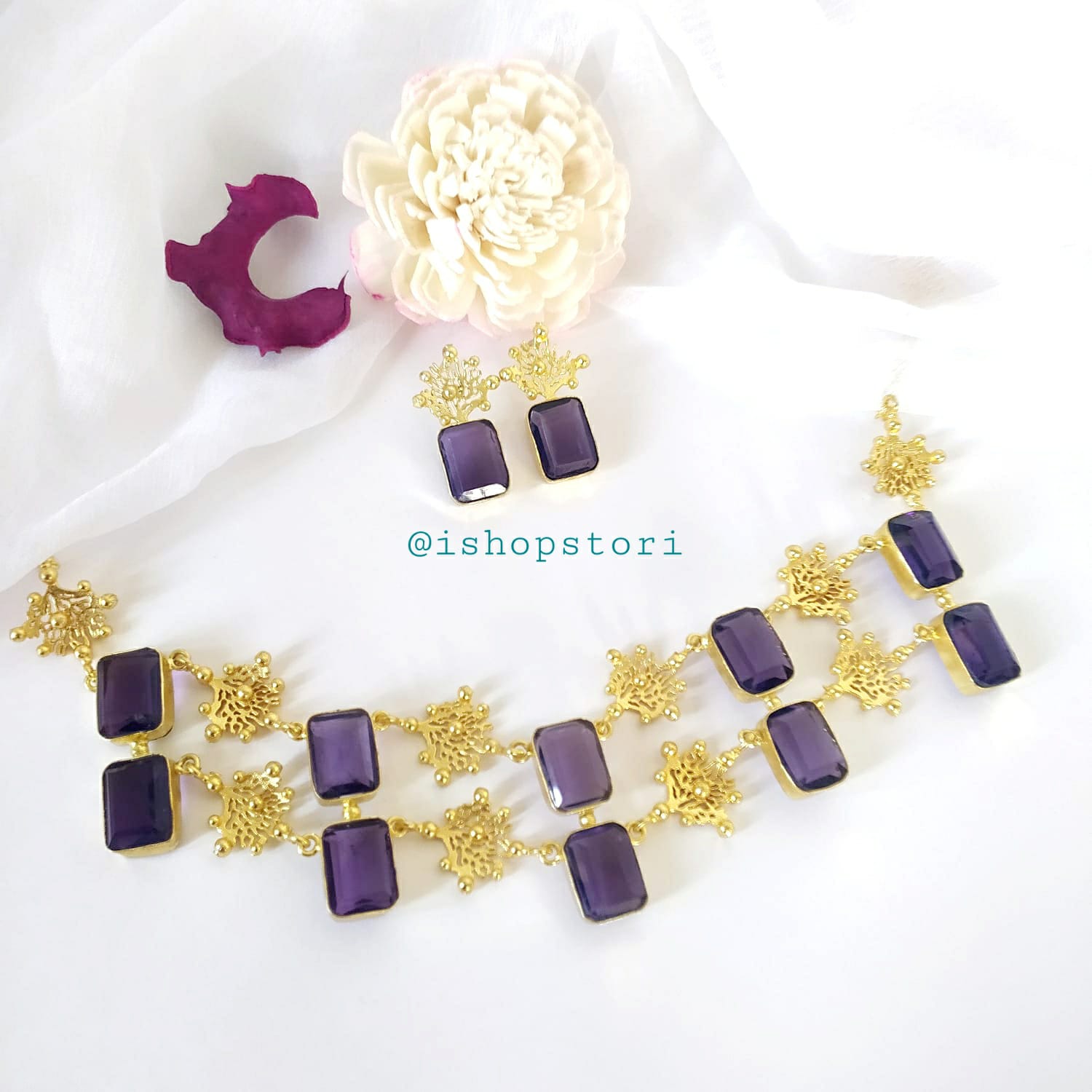 Glossy white stone necklace with a double-layer design and violet earrings.