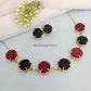 Multi-color raw stone claw necklace in a stylish design with black earrings.