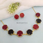 Multi-color raw stone claw necklace in a stylish design with dark red earrings.