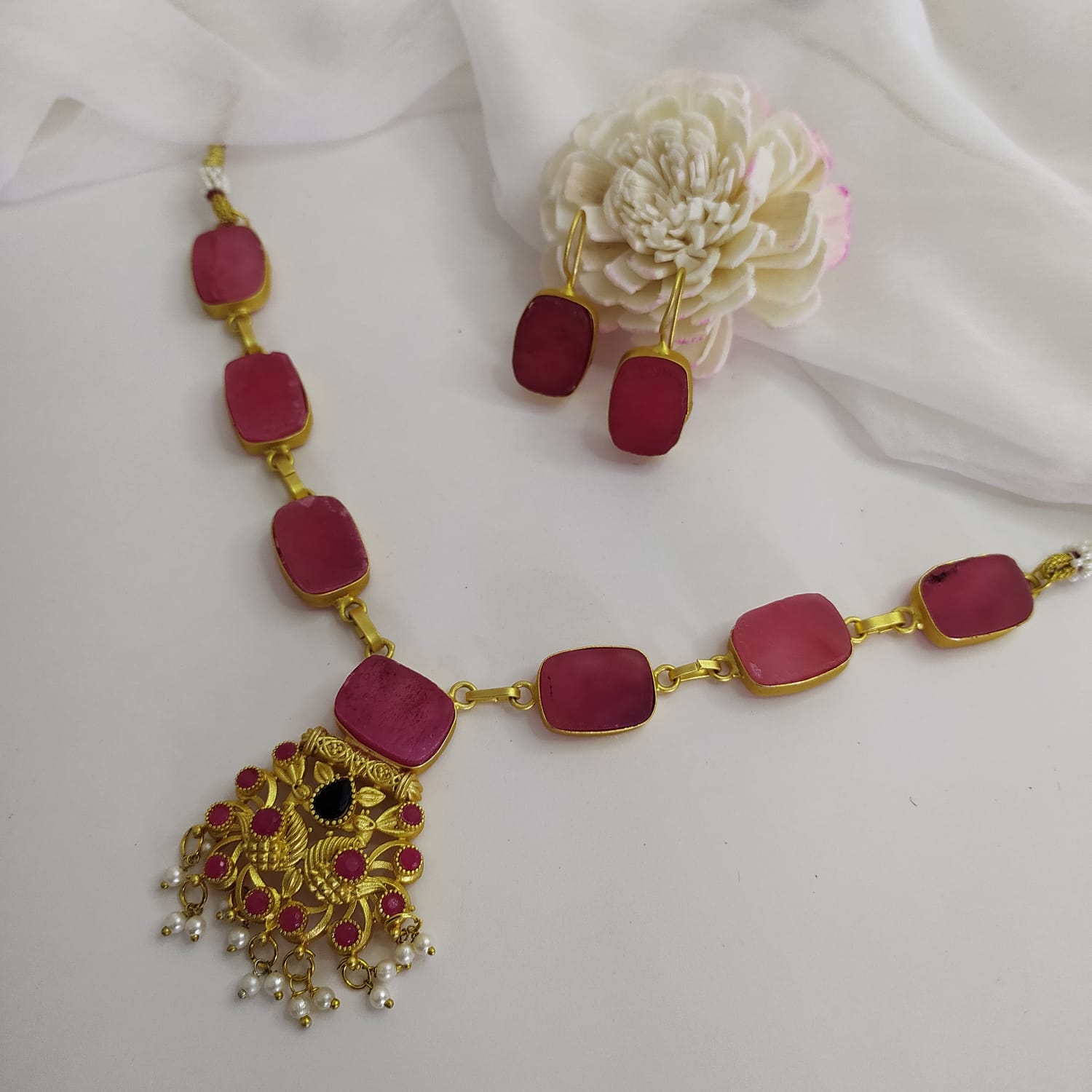 Pink quartz statement necklace set with a timeless design front view.