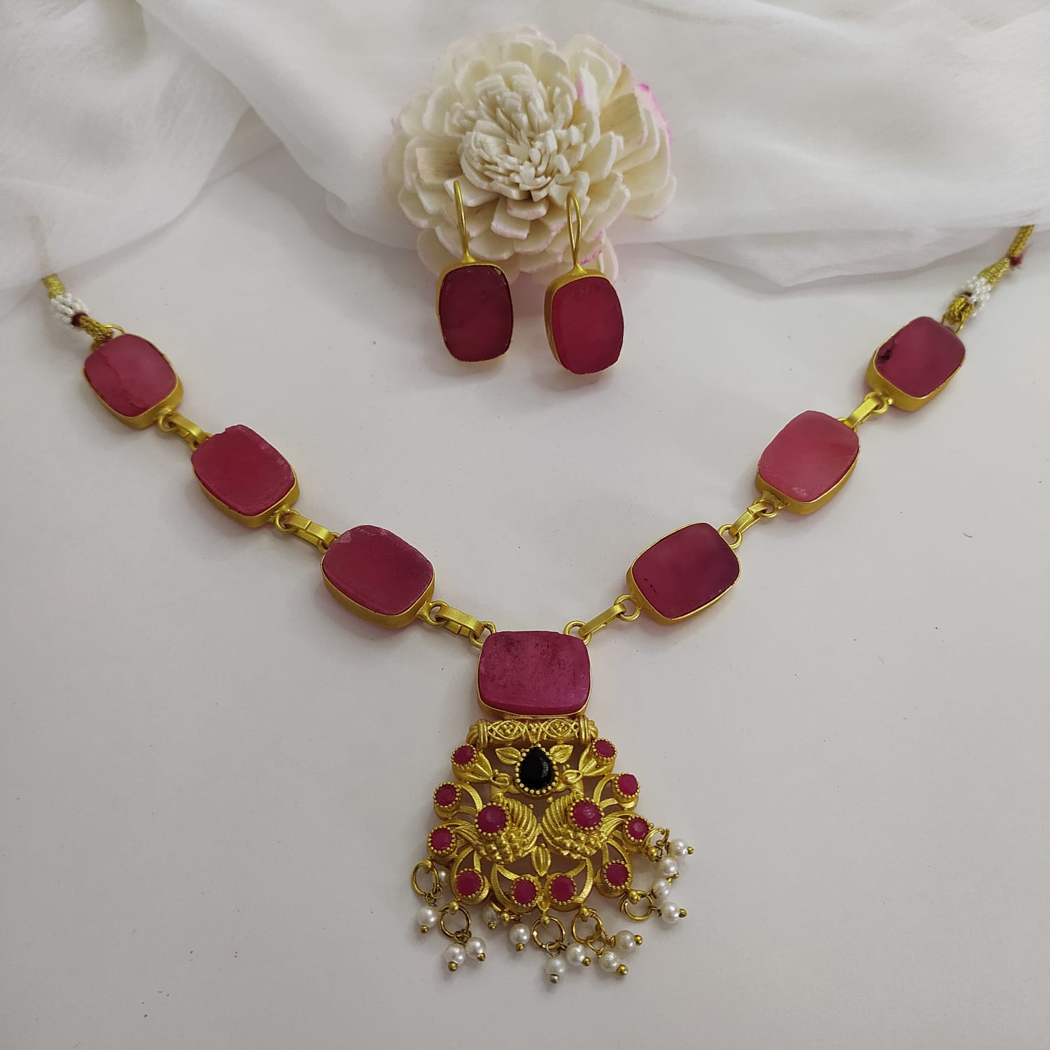 Pink quartz statement necklace set with a timeless design full view.