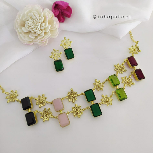 Glossy white stone necklace with a double-layer design and green earrings.