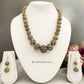 Black and golden pearl choker necklace with matching earrings.