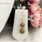 Black and golden pearl choker necklace with matching earrings view.